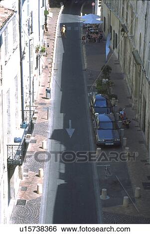 Stock Photograph - seen, cafe, motorcycle, cars, pedestrian, alley. Fotosearch