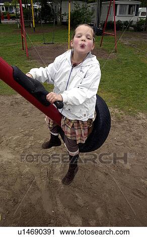 Stock Image - swing, child, tire, disrespect, kid, playing. Fotosearch