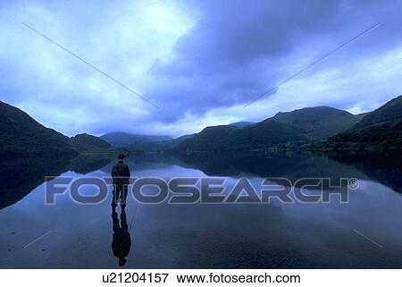 Stock Photo - twilight, person, fishing, lake, ellswater, water. Fotosearch