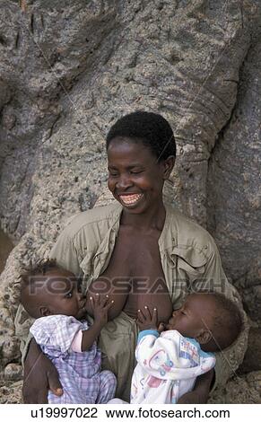 Stock Image - twins, people, feeding, ghana, person, woman. Fotosearch