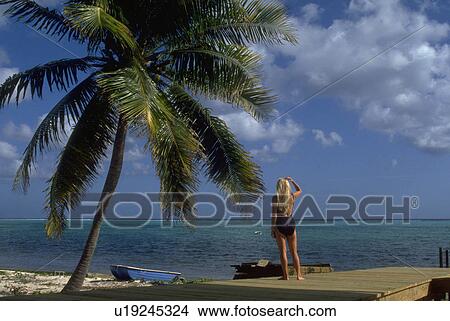 Picture - wooden, blonde, stands, female, woman, young. Fotosearch