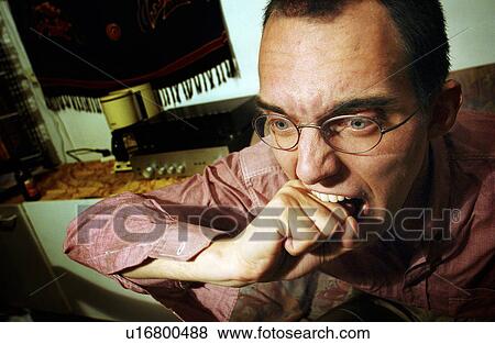 Stock Photo - anger, knuckles, biting, male, frustration. Fotosearch