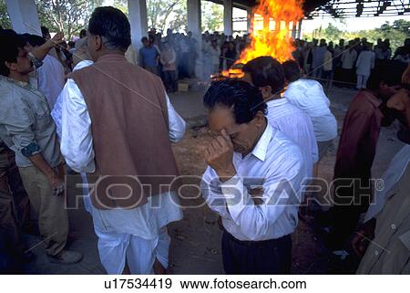 Stock Photo - anguish, fire, grief, india, cremation, people. Fotosearch