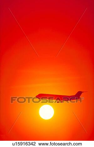 Stock Image - bright, sunset, beautiful, august, sun, airplane. Fotosearch