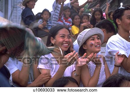 Stock Image - crowd, two, middle, girls, young, party. Fotosearch