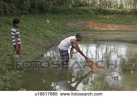 Stock Photography - father, people, bangladesh, fish, person, water. Fotosearch
