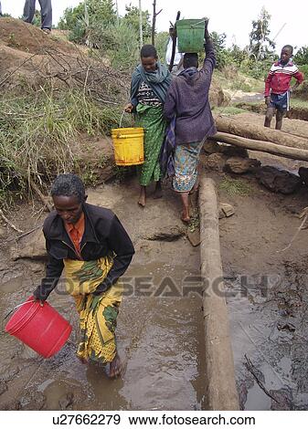 Stock Photo - females, people, tanzania, women, person, water. Fotosearch