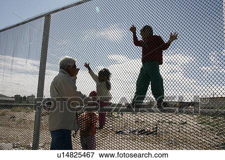 Stock Photo - fence, border, usa, children, person, people. Fotosearch