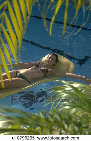 Stock Photography - girl, palms, tropical, bikini, pretty. Fotosearch