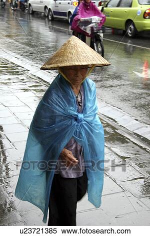 Stock Photography - hanoi, person, day, rainy, vietnam, people. Fotosearch