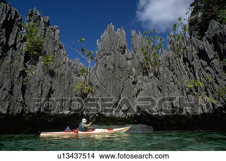 Picture - jagged, kayak, cove, rockface, water. Fotosearch