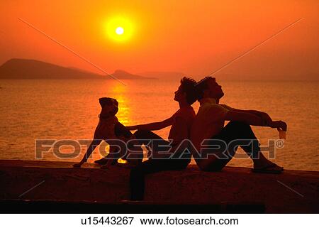 Stock Photo - leisure, dog, greece, hydra, sunset, couple. Fotosearch