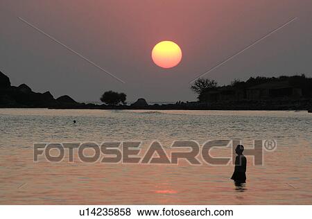 Stock Photo - palolem, person, sunset, india, sun, people. Fotosearch
