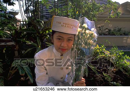 Stock Photograph - philippines, girl, manila, holding, uniform, flowers. Fotosearch