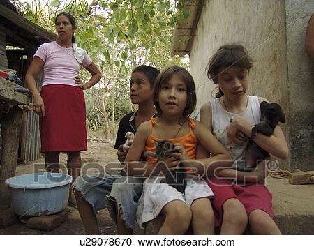 Stock Image - puppies, person, farm, salvador, children, people. Fotosearch