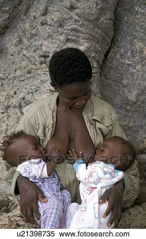 Stock Photography - twins, people, feeding, ghana, person, woman. Fotosearch