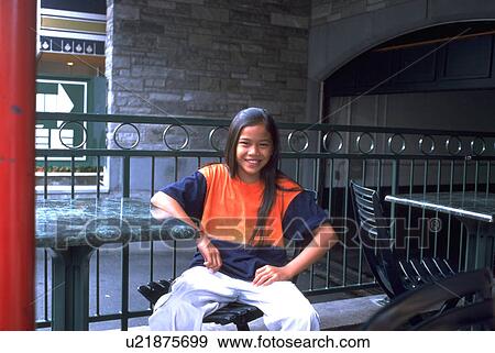 Stock Photo - young, montreal, smiling, sitting, girl. Fotosearch