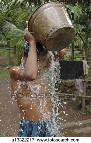 Stock Photo - bath, person, taking, boy, cambodia, people. Fotosearch
