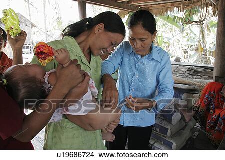 Picture - clinic, hand, immunisation, cambodia, person, people. Fotosearch