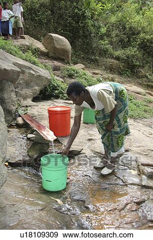 Stock Photo - female, water, tanzania, person, people, woman. Fotosearch