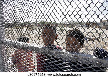 Stock Image - fence, border, usa, children, person, people. Fotosearch