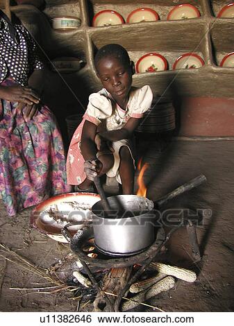 Stock Photograph - girl, zambia, fire, person, people. Fotosearch