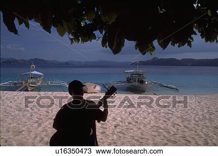 Stock Image - guitar, water, boats, pontoon, banca, beach. Fotosearch