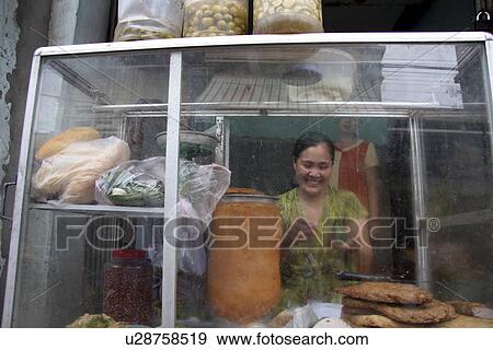 Stock Photo - hanoi, people, stall, vietnam, person, food. Fotosearch