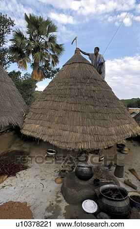 Stock Image - house, traditional, benin, person, people. Fotosearch