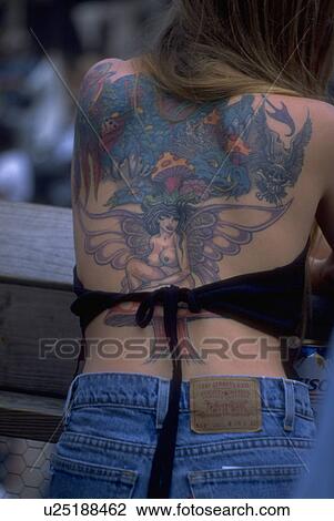 Stock Image - iron, tattoo, female, woman, young, colorful. Fotosearch