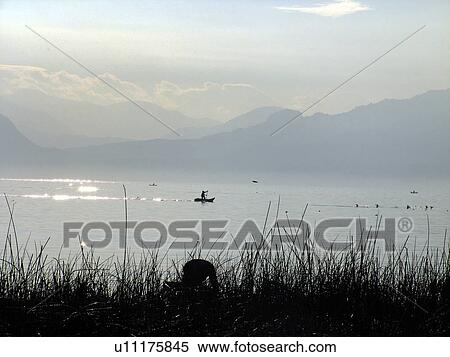Stock Photography - lake, person, fishing, men, guatemala, people. Fotosearch