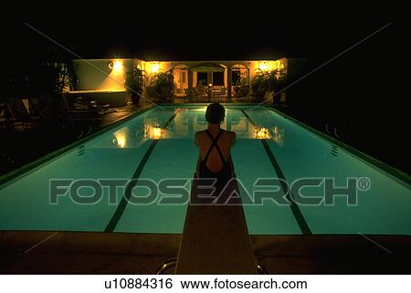 Stock Photograph - lit, woman, silhouetted, sits, female, young. Fotosearch
