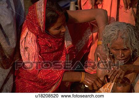 Stock Image - mother, love, bathing, female, hindu, woman. Fotosearch