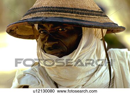 Stock Image - nomad, conical, woven, wears, male. Fotosearch