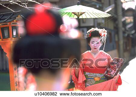 Stock Image - old, geisha, through, walk, umbrella, woman. Fotosearch