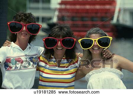 Stock Photography - oversized, young, wear, females, women, three. Fotosearch