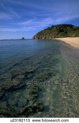 Stock Image - palawan, coral, busuange, promontory, rocky, beach. Fotosearch