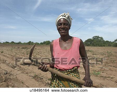 Picture - people, zambia, hoe, person, woman. Fotosearch