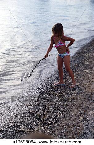 Picture - poking, kid, water, playing, girl, child. Fotosearch