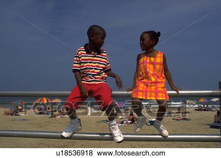 Stock Photo - railing, young, sit, kids, children, two. Fotosearch