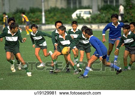 Stock Image - singapore, fitness, children, sport, football, people. Fotosearch