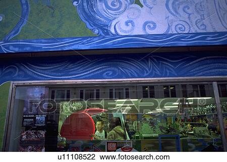 Stock Image - store, retro, lit, exterior, shopping, couple. Fotosearch