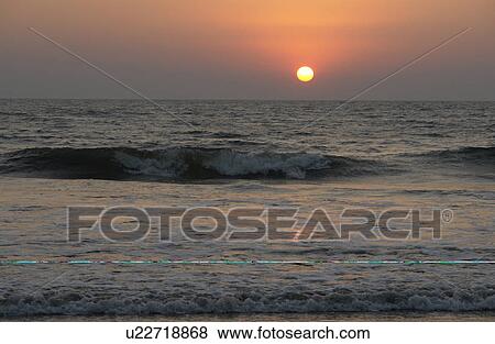 Stock Photo - sunset, people, india, sun, person, beach. Fotosearch