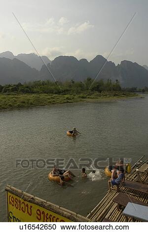 Stock Image - tubing, people, tourists, laos, person, water. Fotosearch