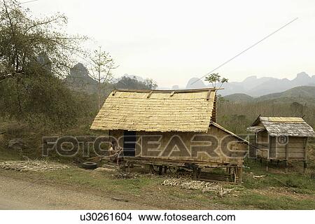 Picture - vang, house, road, laos, person, people. Fotosearch