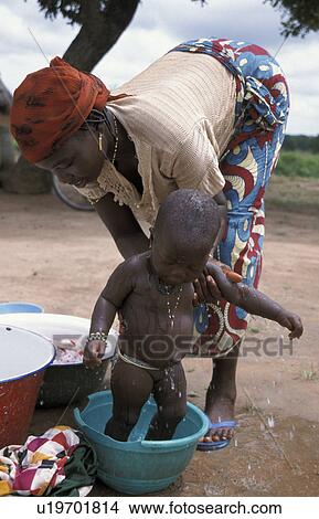Picture - washing, baby, benin, person, people, woman. Fotosearch