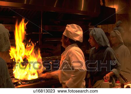 Stock Image - assistants, fire, stove, cooking, chef, food. Fotosearch