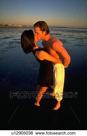 Stock Photo - beach, couple, people, love, woman. Fotosearch