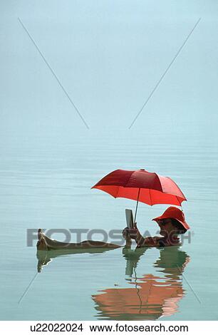 buoyant, female, easily, umbrella, floats, woman View Large Photo Image Picture - buoyant, female, easily, umbrella, floats, woman. Fotosearch