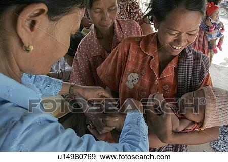 Stock Photo - cambodia, hand, babies, mothers, person, people. Fotosearch